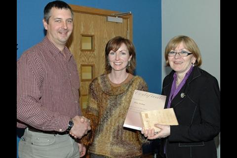 Steve Hart, project manager at pcm consulting, presenting the prize to Delia Keeling (middle)
